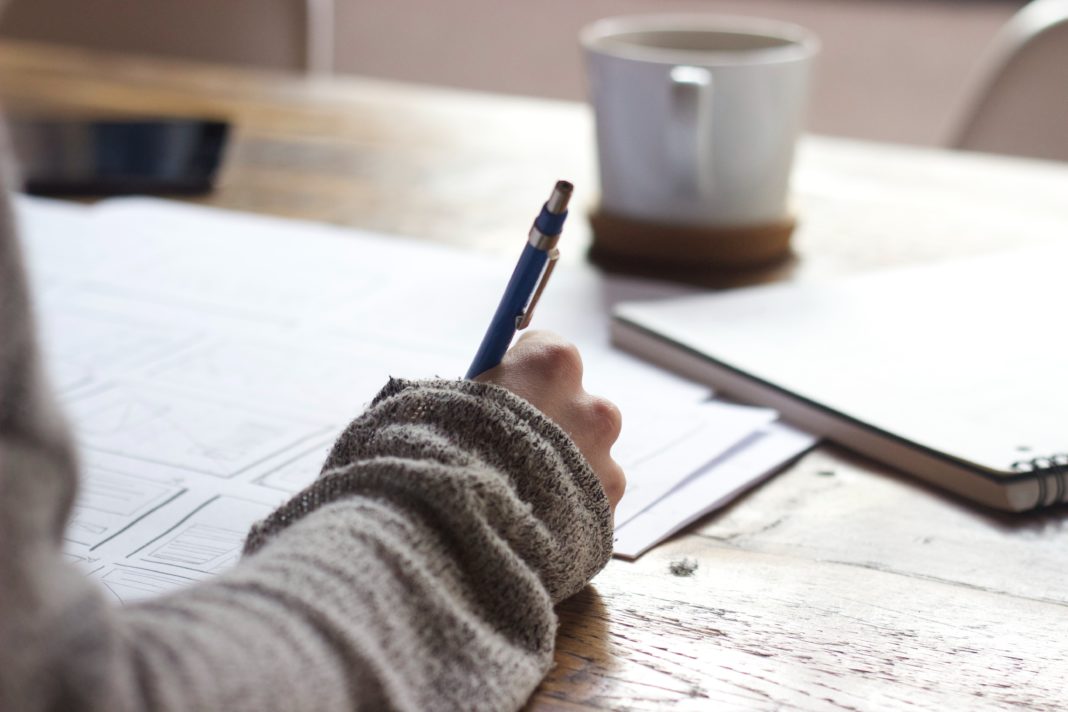 Female doing work with a notebook and coffee