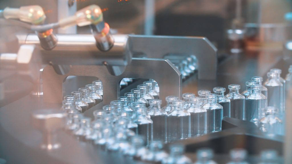 Glass bottles in production in the tray of an automatic liquid dispenser