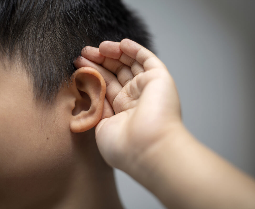 Portrait of little Asian boy with hearing problem