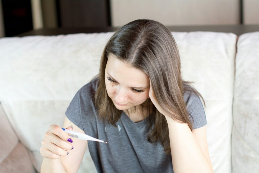 Person holding thermometer