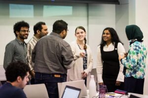 Dhireesha Kudithipudi, PhD, (second from right), founding director of MATRIX at UTSA, chats with students during the NSF AI Spring School at UTSA's San Pedro I building. [The University of Texas at San Antonio]